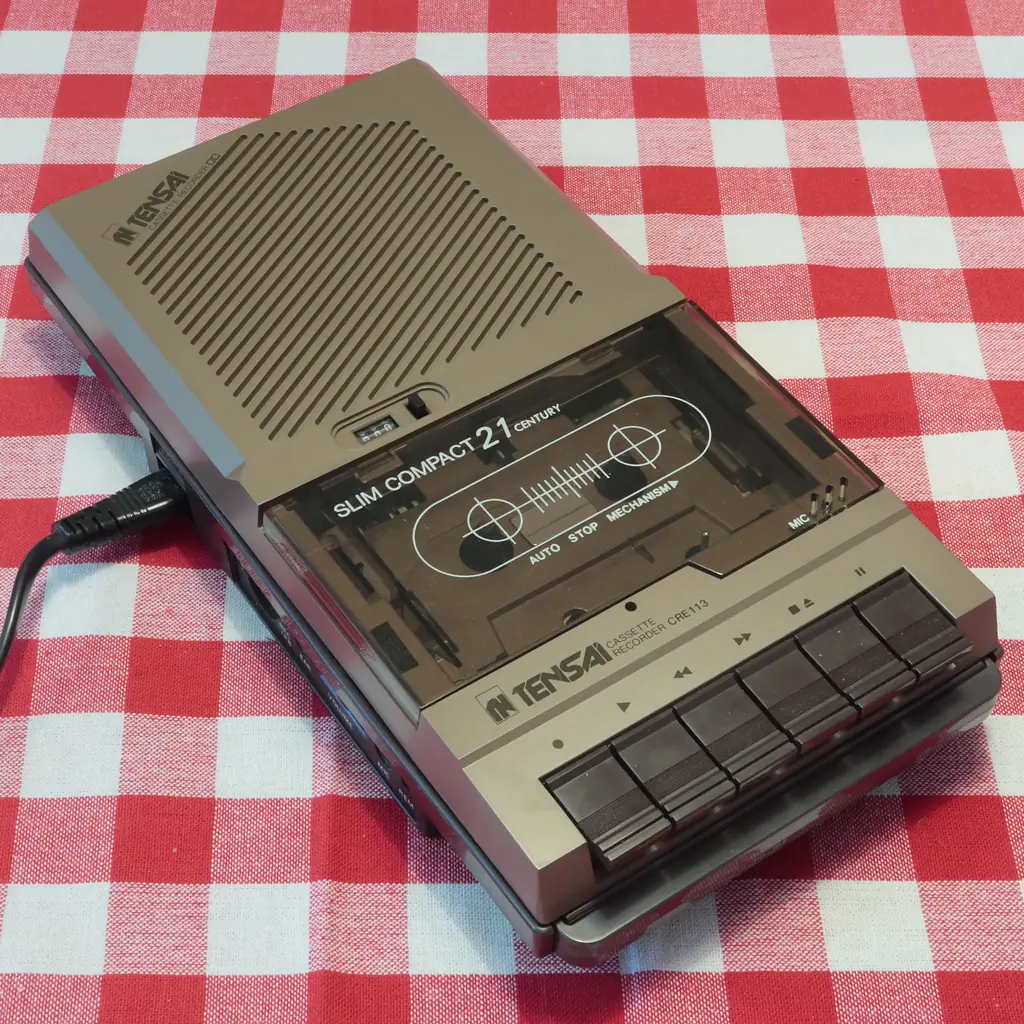 A Tensai radio cassette recorder on a gingham tablecloth.