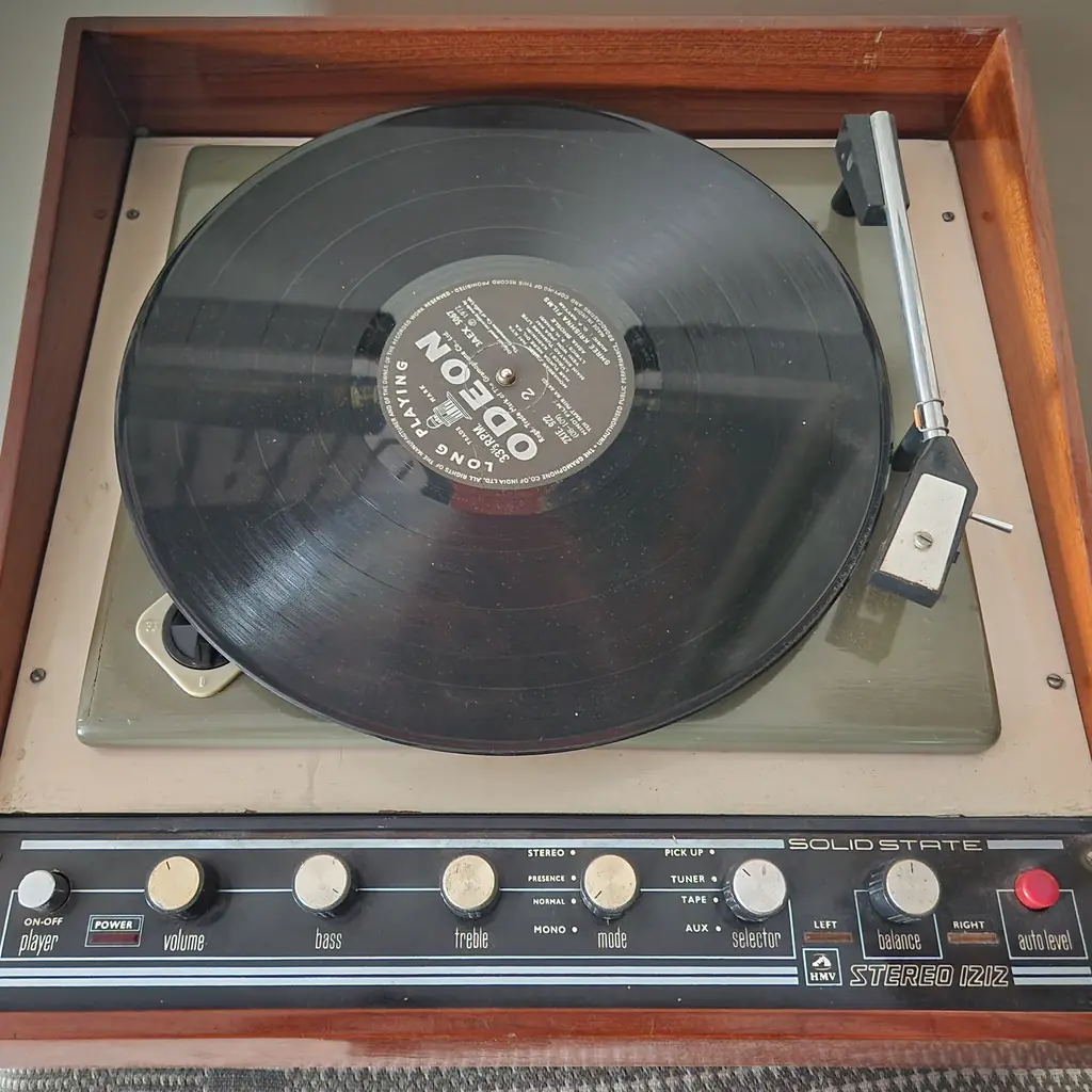 An HMV record player with a record on the platter.