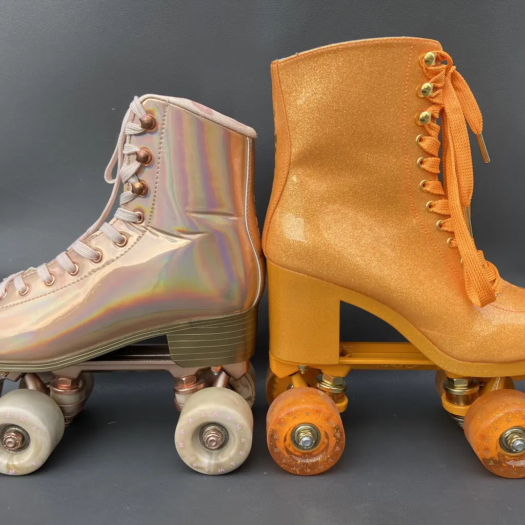 A pair of white quad roller skates.